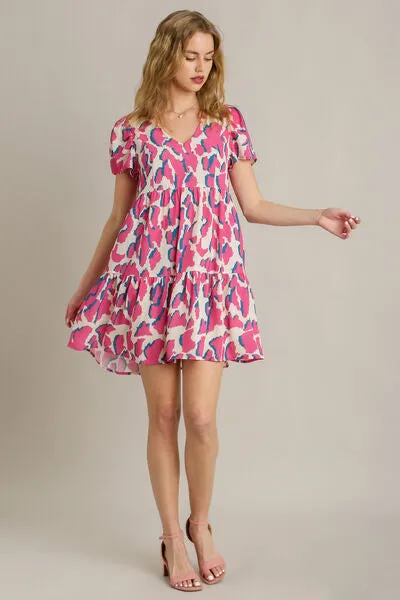 Umgee Full Size Abstract Print Pleat Detail Short Sleeve V-Neck Tiered Dress Plus Size